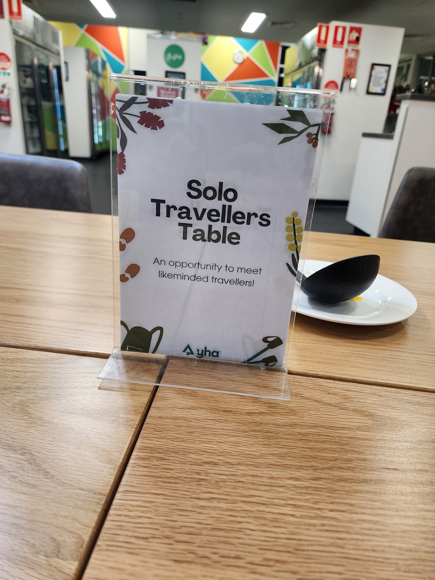 Solo travellers table sign inside YHA Sydney Harbour